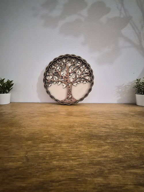 Tableau artisanal en bois pour suivi des commandes annuelles, décor arbre de vie, sur table.